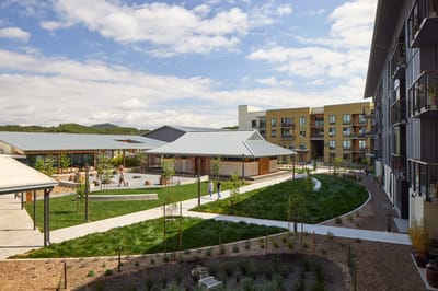 Residents enjoying a stroll in a landscaped outdoor space