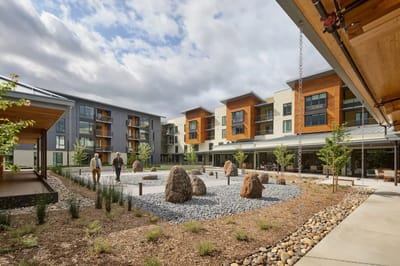 Residents enjoying a peaceful outdoor space with gardens