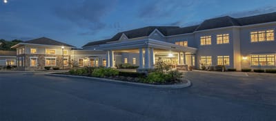 Exterior view of Coburg Village facility at dusk
