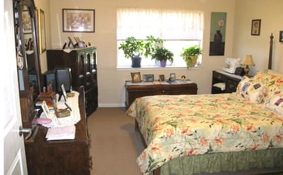 Cozy resident room with floral bedding and plants