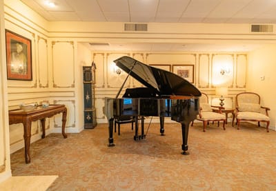 Elegant common area with a grand piano and seating