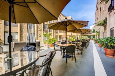 Outdoor patio area with tables and umbrellas