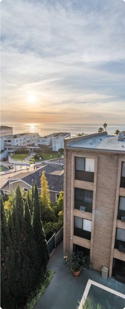 Exterior view of the facility near the ocean at sunset