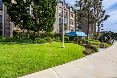 Building exterior with manicured landscaping and entrance awning
