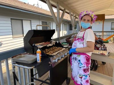 Staff member grilling outdoors for residents