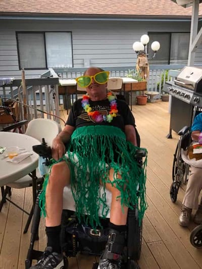 Resident enjoying themed outdoor activity with festive attire.