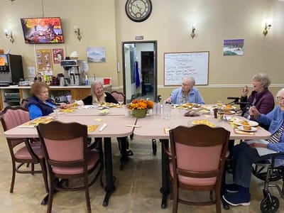 Residents enjoying a meal together in the dining room