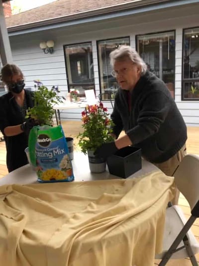 Residents gardening on an outdoor patio