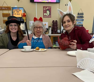 Residents and staff enjoying a tea party together