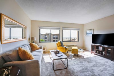 Cozy living room with large windows and ocean view