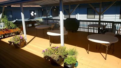 Outdoor patio area with seating and flowers