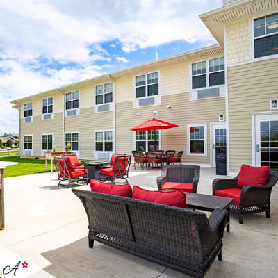 Patio area with chairs and umbrella near the building