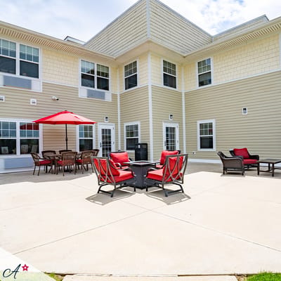Outdoor seating area with red chairs and umbrellas