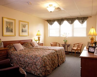 Cozy resident room with twin beds and decor
