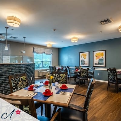 Dining area with tables set and floral decorations