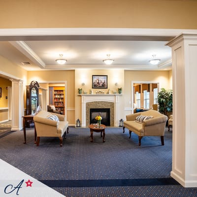 Bright common area with seating and a fireplace