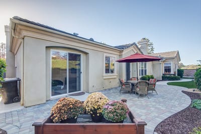 Outdoor patio area with seating and flowering plants