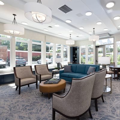 Bright common area with modern furniture and large windows