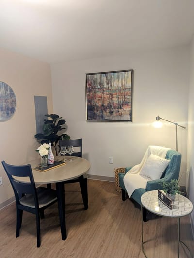 Cozy interior of a resident room with dining table and artwork