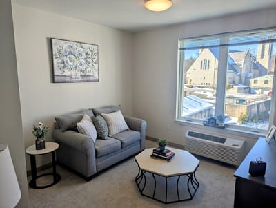 Cozy living area with natural light in a senior living facility