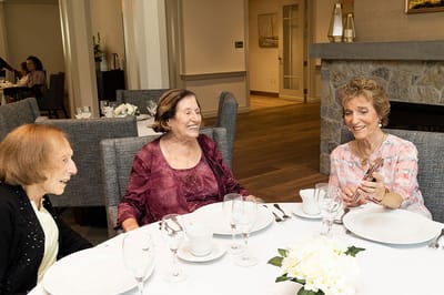 Residents enjoying a meal together in the dining room