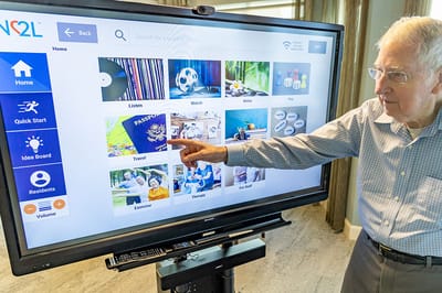 Senior resident interacting with an activity screen