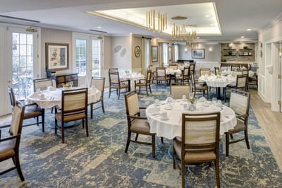 Dining room set up for meal service with tables and chairs