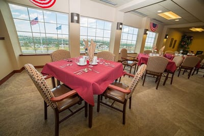 Interior view of a dining room with tables set for a meal