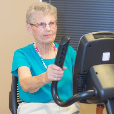 Senior woman exercising on a stationary bike