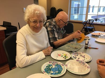Residents engaged in a creative activity with beads