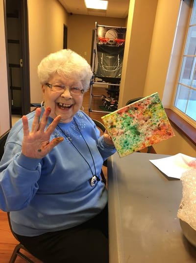 Resident painting with colorful materials