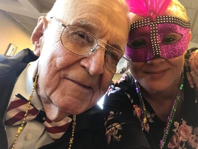 Resident and staff member during a festive event