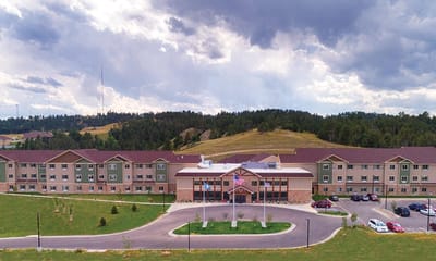 Aerial view of the facility building surrounded by green space