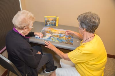 Residents working on a puzzle together at a table