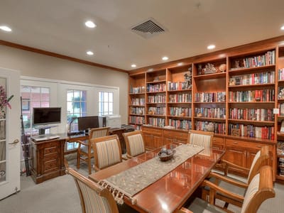 Interior common area with bookshelves and dining table
