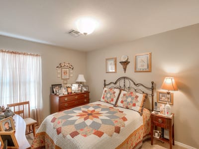 Cozy resident room with a quilt and personal touches