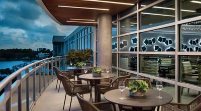 Outdoor seating area with tables and plants