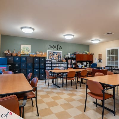 Activity room with tables and chairs set up