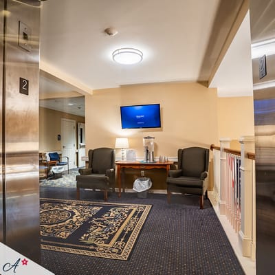 Bright common area with seating near elevator