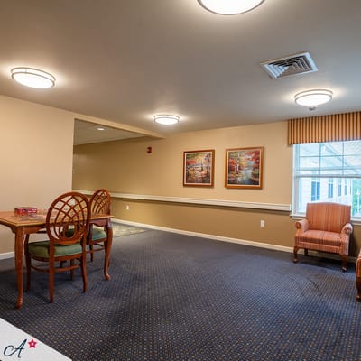 Bright common area with tables and artwork
