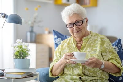 Senior woman enjoying tea in a cozy living room