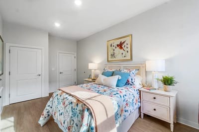 Brightly decorated private resident room with bed and decor