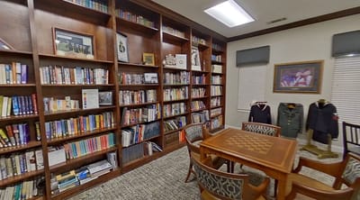 Cozy library area with bookshelves and chess table