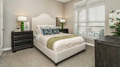 A well-decorated resident room with a bed and furnishings