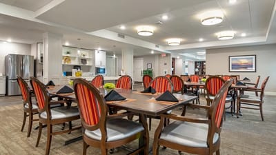 Dining area with tables and chairs set for meals