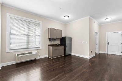 A spacious interior room with kitchenette