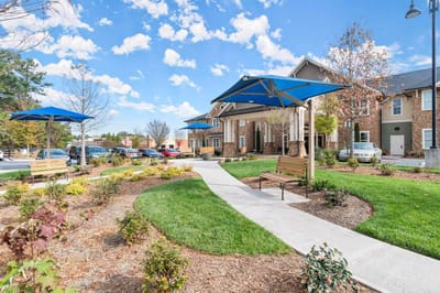 Outdoor space with benches and blue umbrellas