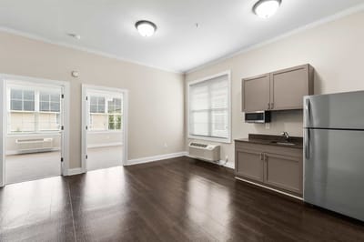 Bright interior of a private resident room with kitchenette
