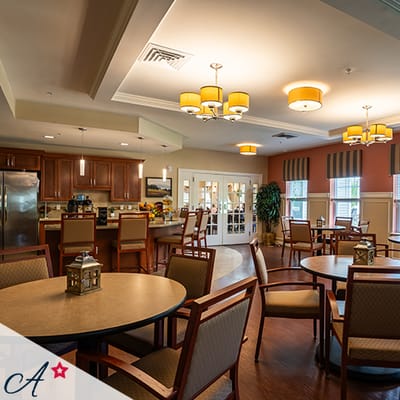 Bright common area with dining tables and chairs