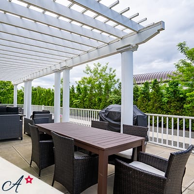Outdoor seating area with table and chairs under a pergola